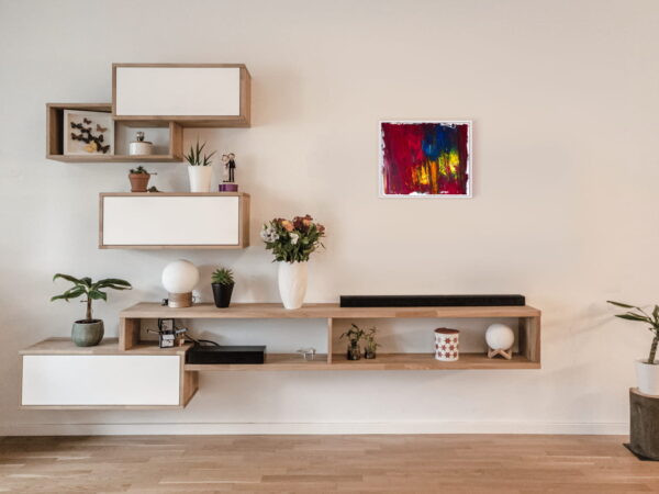 Le tableau Colère côtoie des meubles accrochés au mur d'un large pièce